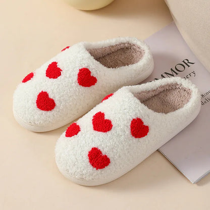 Adult women's plush home slipper in a cartoon love design with a round toe and non-slip PVC sole.