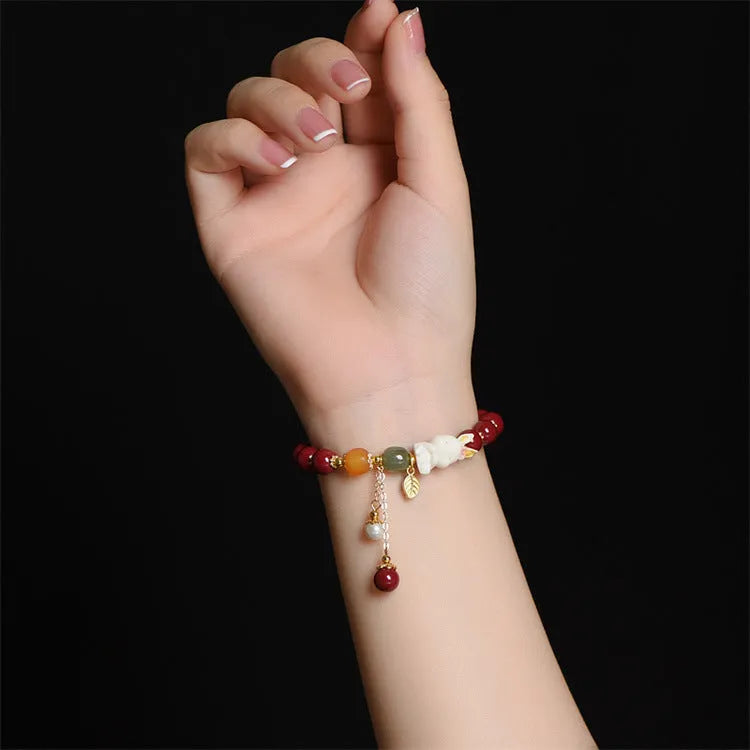 Traditional Chinese cinnabar bracelet with bunny design in purple-gold sand colour