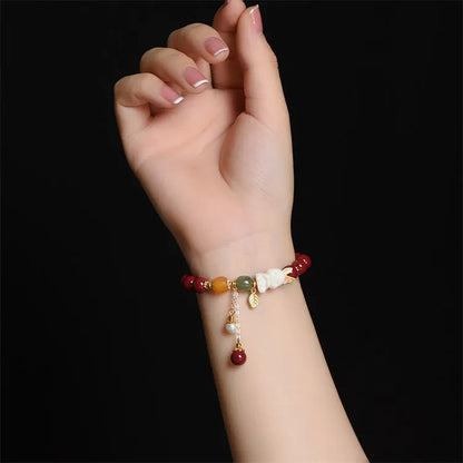 Traditional Chinese cinnabar bracelet with bunny design in purple-gold sand colour