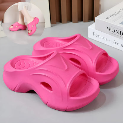 Women's white thick-soled EVA slippers with a round toe on a beach background.