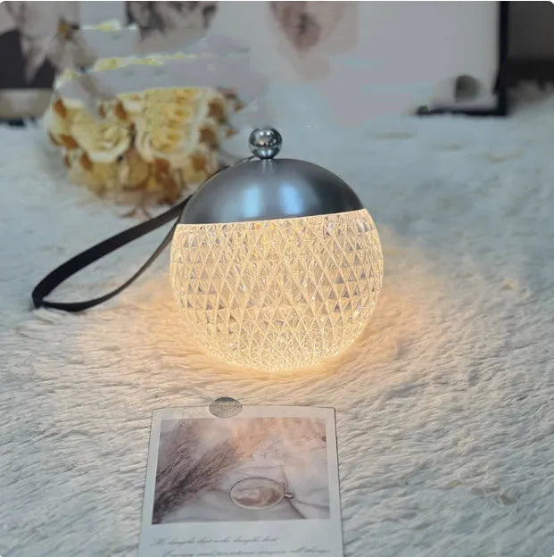 Small portable desk lamp with touch dimmer in gold finish, 12cm tall.