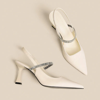 Black women's stiletto sandals with pointed toe and buckle strap closure