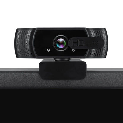 Black USB webcam with microphone on a laptop screen, showing 360-degree rotation and universal clip.