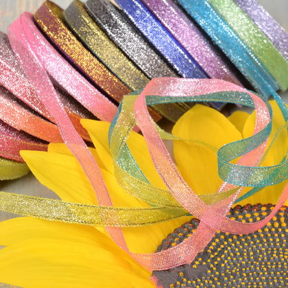 Close-up of green onion patterned ribbon with gold wire on a 25-yard roll, showing 3-points width.