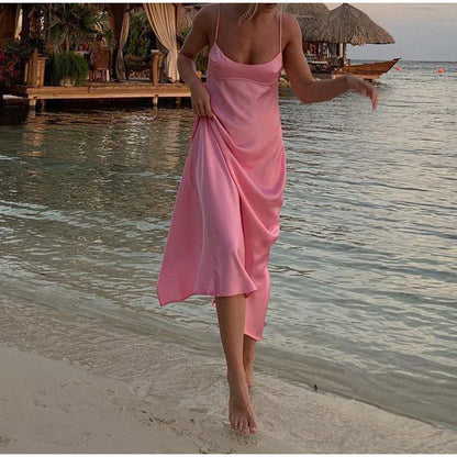Elegant satin slip dress in pink with a square neckline, sleeveless design, and backless detail