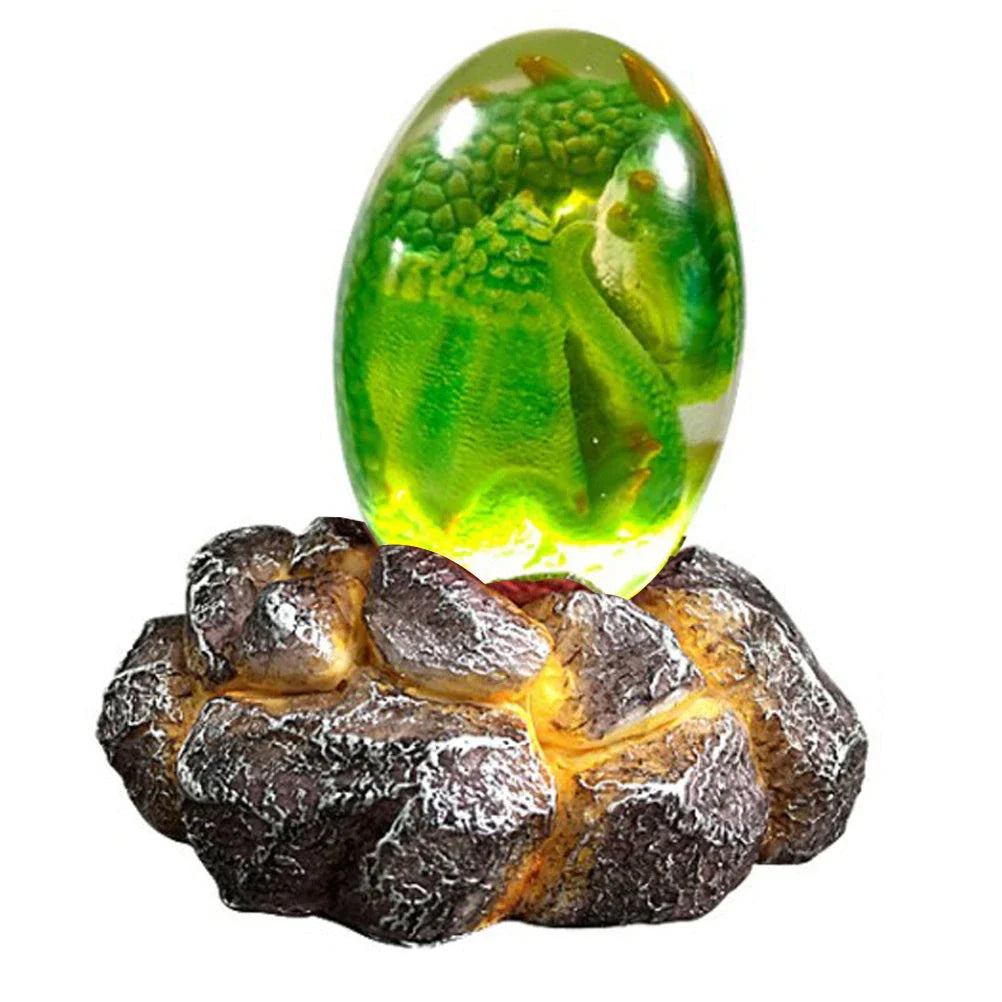 A lifelike resin dragon egg ornament with a crystal-clear, transparent design, sitting on a glowing lava-style base.