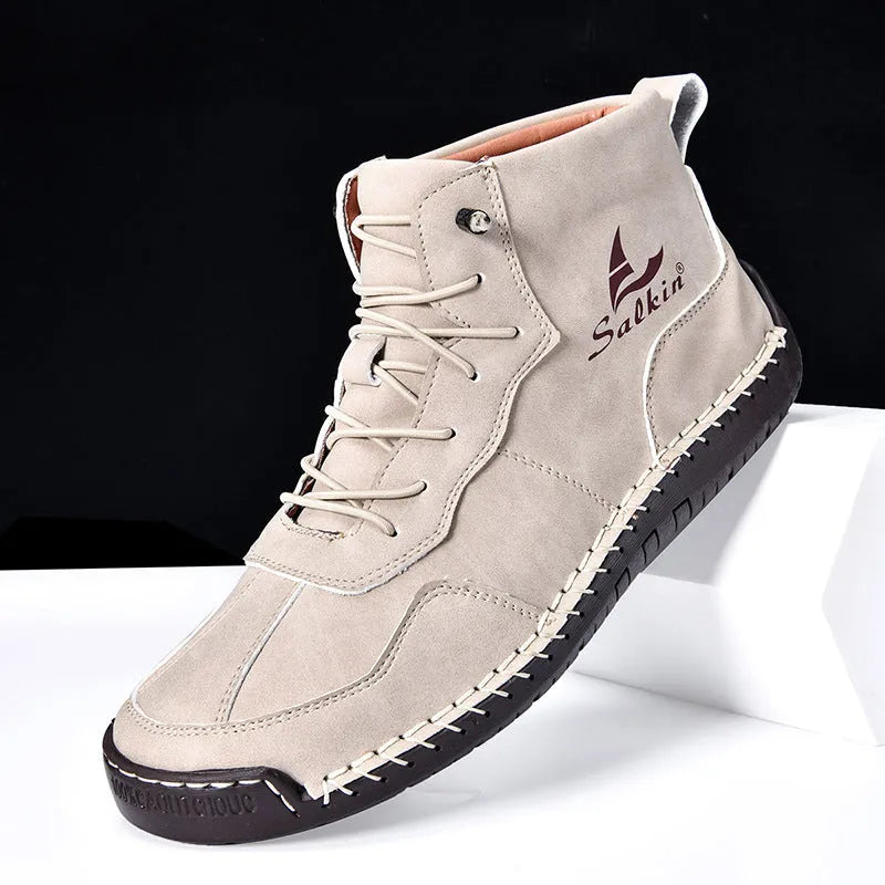 A pair of beige high-top casual boots with elastic band fastening and a flat rubber sole.