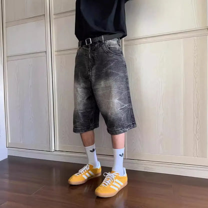 Man wearing loose light blue washed denim shorts with a straight leg and cropped length.