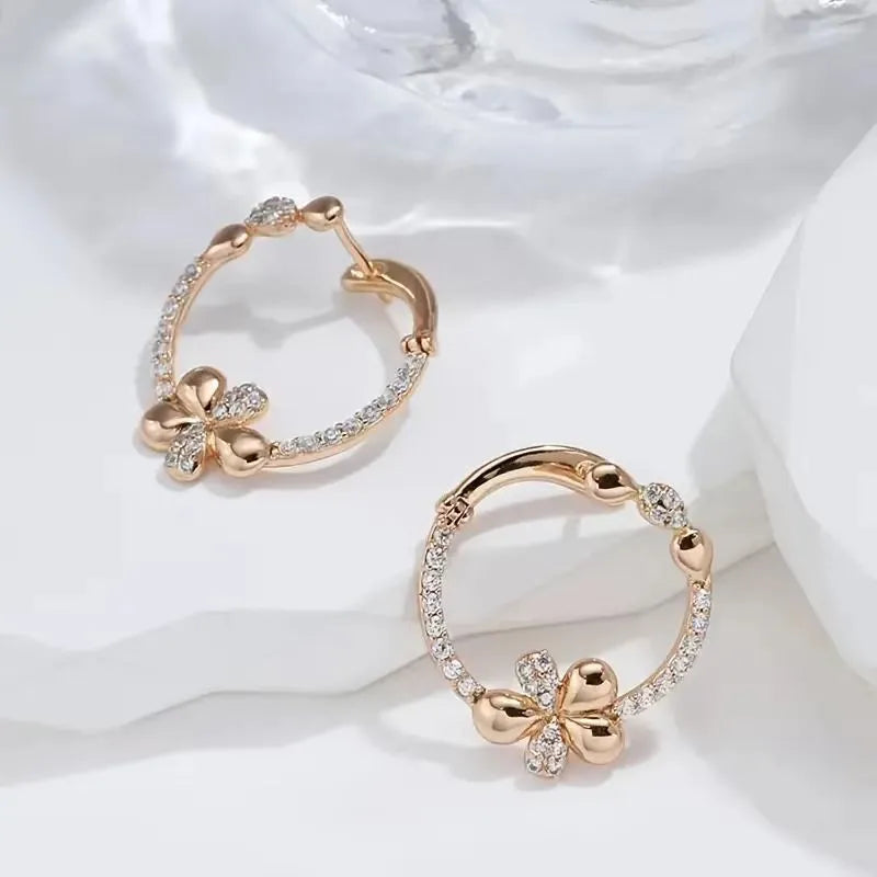 A pair of round ring earrings for women made from electroplated copper with a geometric design.