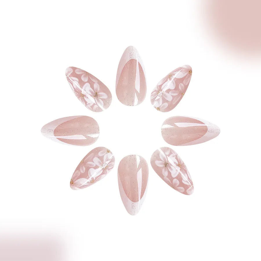 Short glossy almond false nails with glittering powder flower designs in C625 colour