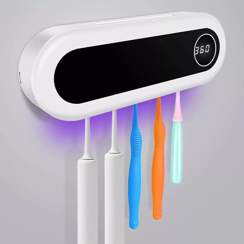 Wall mounted toothbrush holder with UV sterilizer and toothpaste dispenser in ivory white