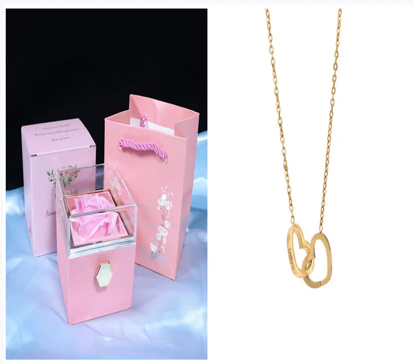 Rotating rose jewellery gift box with a preserved red rose under a clear acrylic dome, showing the interior rotating drawer.