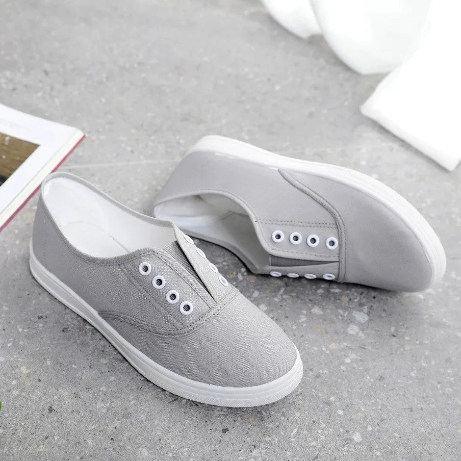 A pair of low-top canvas casual trainers in a choice of colours, shown on a flat surface.