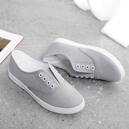A pair of low-top canvas casual trainers in a choice of colours, shown on a flat surface.