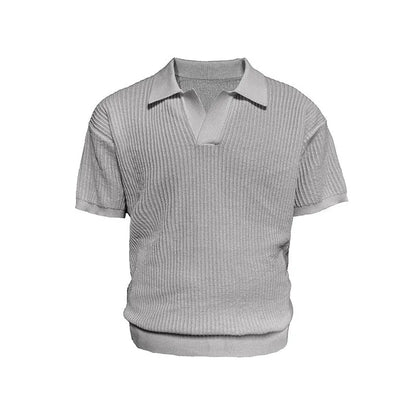 Short sleeve men's polo shirt in grey with striped collar, shown on a hanger.