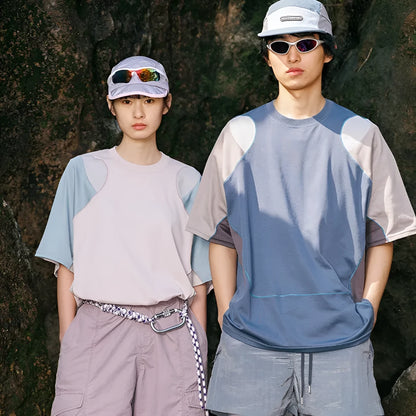 Man wearing a loose blue patchwork contrast colour short sleeve cotton blend sports t-shirt.