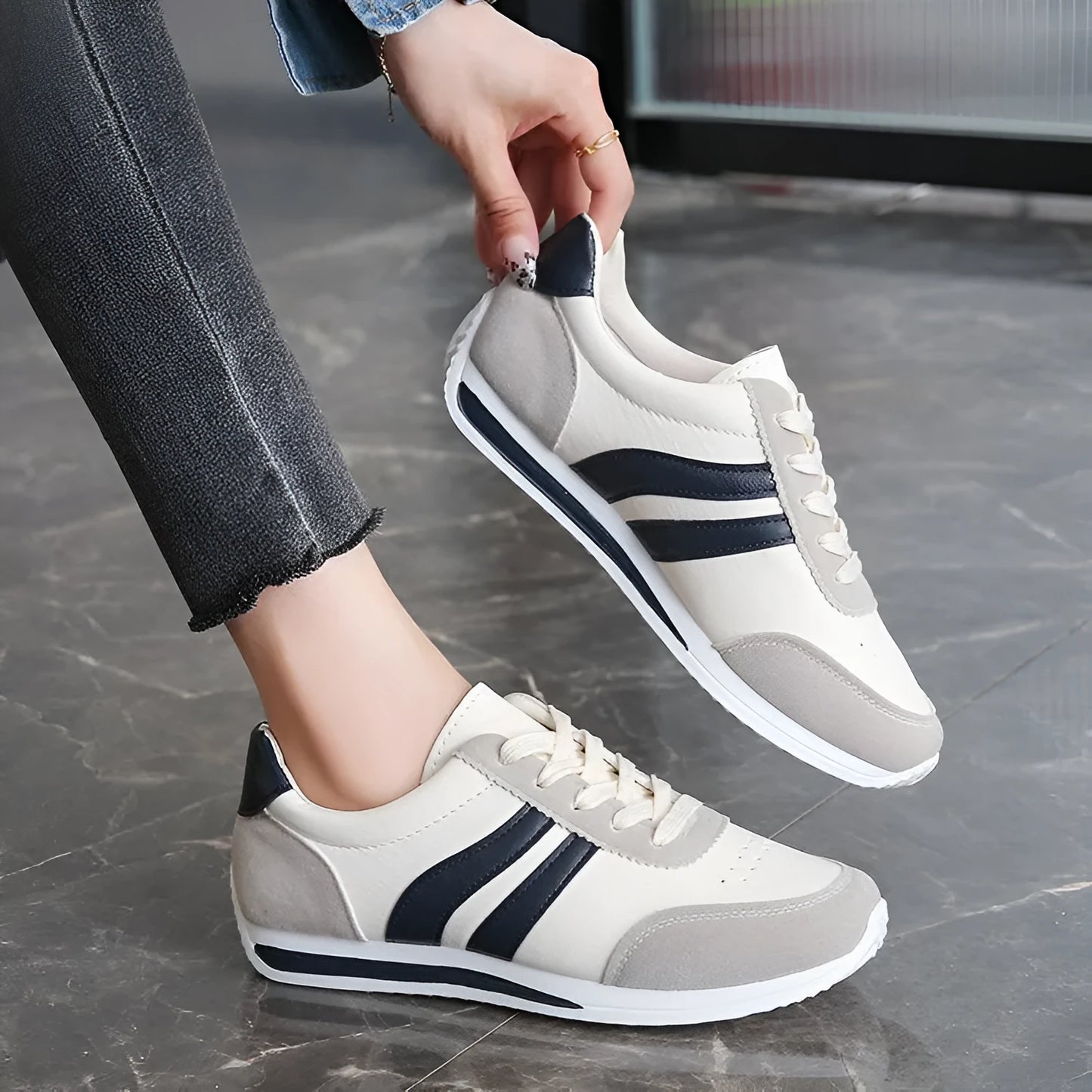 Blue and red low-top lace-up sneaker with soft rubber soles and mesh lining