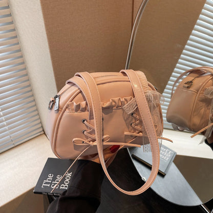 Women's PU leather casual shoulder handbag with a large bandage bow and sewing thread detail.