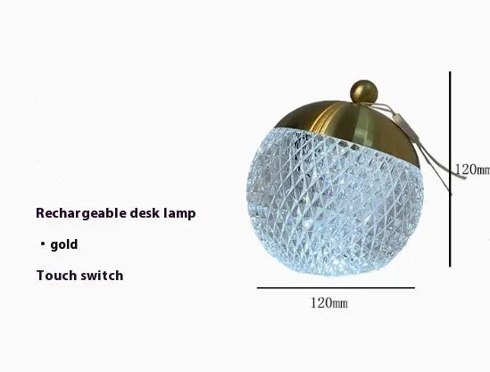 Small portable desk lamp with touch dimmer in gold finish, 12cm tall.