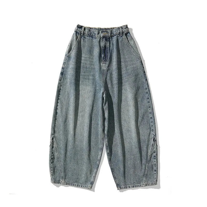 Men's plus-size light blue wide-leg baggy jeans on a neutral background.