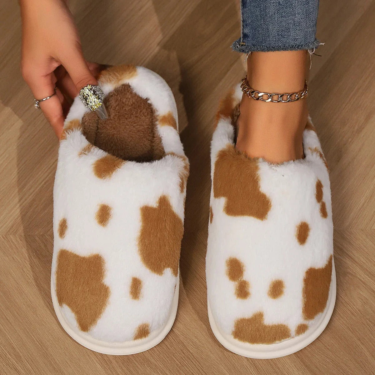 Cozy cow print plush slippers with soft, cushioned soles and non-slip outsoles for indoor comfort and warmth