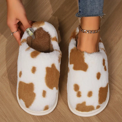 Cozy cow print plush slippers with soft, cushioned soles and non-slip outsoles for indoor comfort and warmth