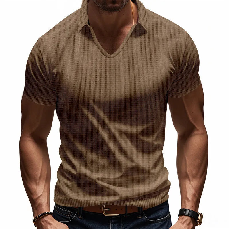 Man modelling a loose-fit apricot coloured V-neck short-sleeve T-shirt for casual summer wear.