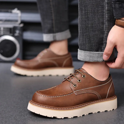 Men's black low-top Martin boot with round toe and non-slip rubber sole on a white background.