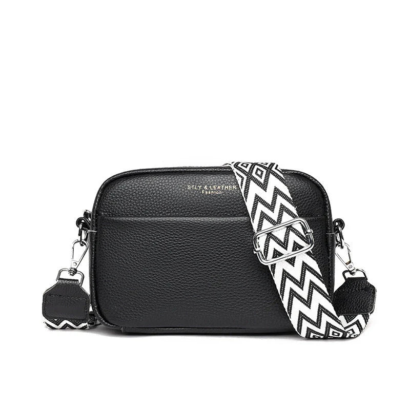 Stylish crossbody bag with rhombus embroidery, wide adjustable shoulder strap, and multiple interior pockets in various color options