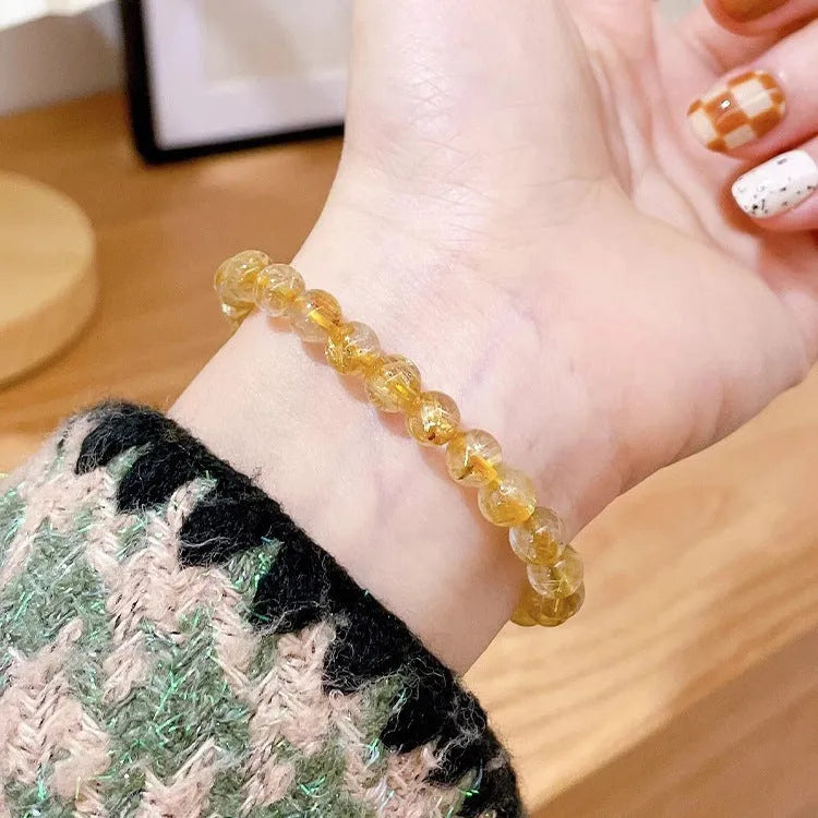 Gold rutilated quartz sunstone crystal bracelet with diamond shape and round elements for women