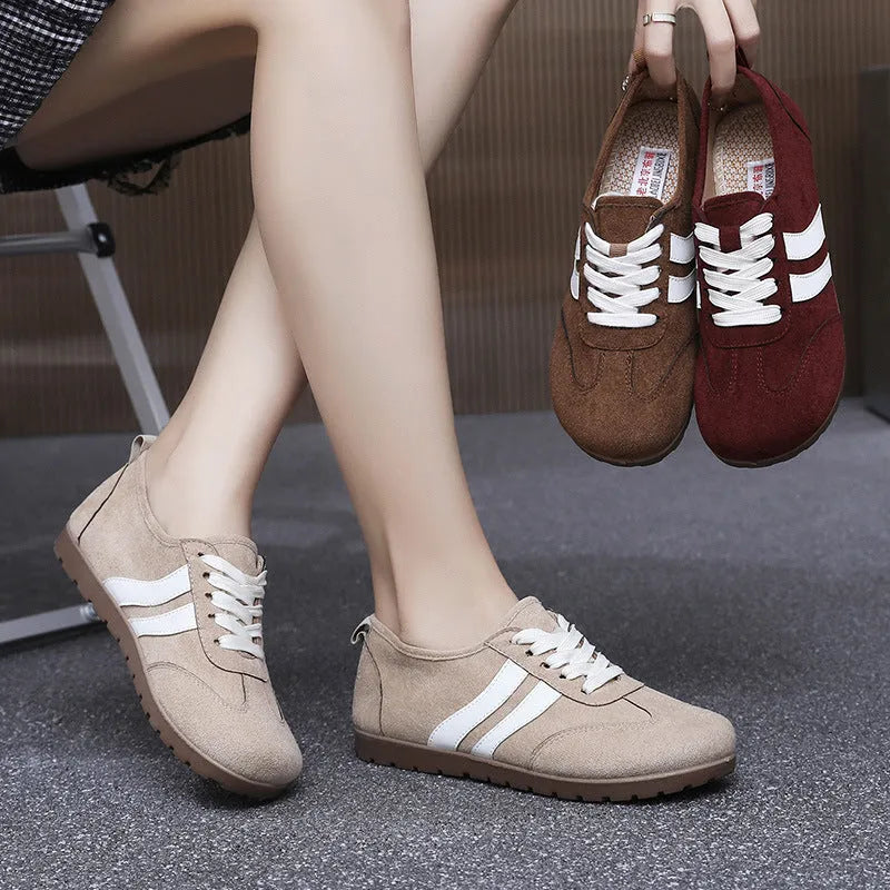 Women's vintage canvas sneakers in dark red with a round toe and flat rubber sole.