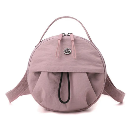 Out shoulder crossbody messenger bag in nylon showing interior zipped changing bag, phone pocket, and document compartment.
