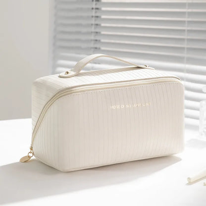 Beige cubic makeup bag with vertical pattern measuring 22.5 by 12.5 by 12.5 centimetres
