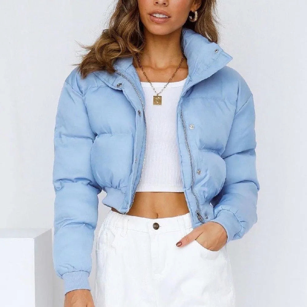 Loose blue polyester jacket for women on a hanger, showing long sleeves and front zip.