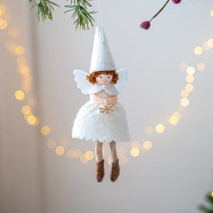 White and pink cloth felt Christmas angel skirt pendant ornament on a tree branch.