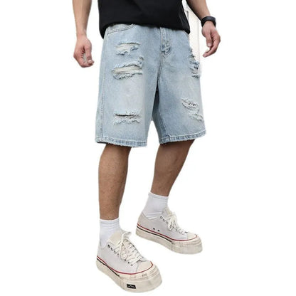 Light blue distressed denim shorts with rips and loose straight fit on mannequin