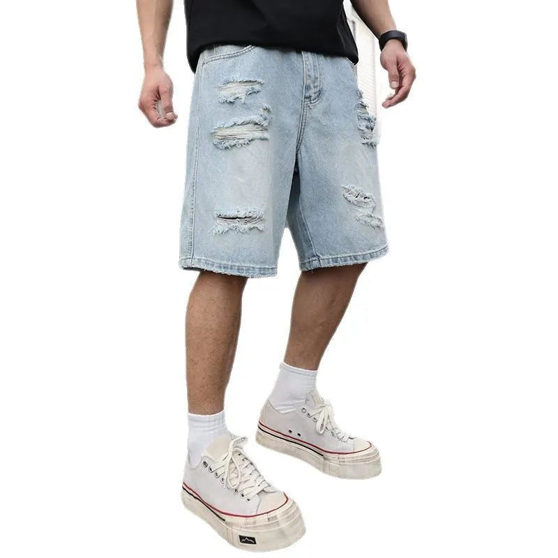 Ripped denim shorts in loose casual straight fit with distressed light blue wash available in Asian sizing from S to 2XL, featuring a cotton-rich fabric blend for everyday hip-hop style wear