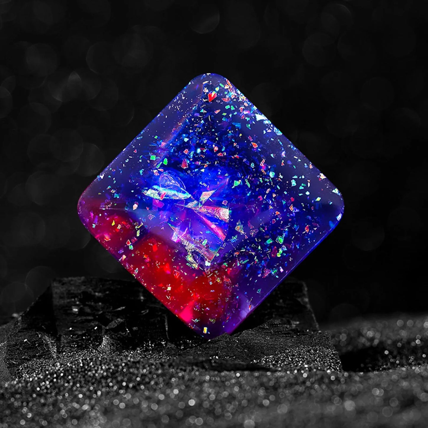 Galactic edition pocket gyro desk toy on a surface, showing its quadrilateral resin construction and celestial colour design.
