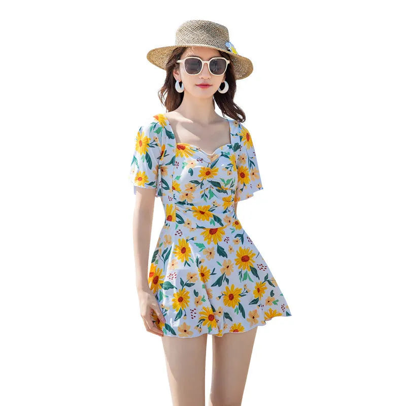 Blue floral print women's dress-style one-piece swimsuit on a hanger