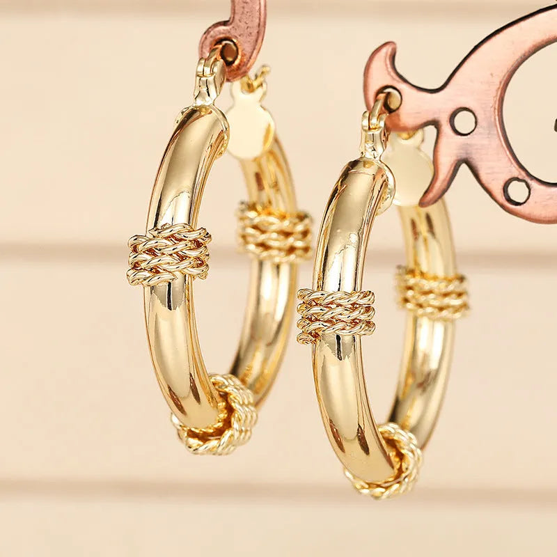 Geometric earring set for women made from copper material with ring and line elements in three golden colour finishes: E4414 Golden, E4435 Golden, and E4441 Golden, designed as a pair of matching ear clips with an advanced aesthetic
