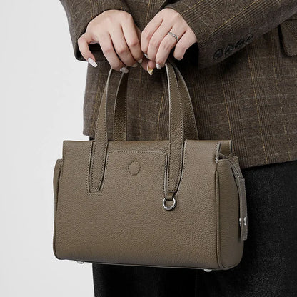 Genuine cowhide leather crossbody bag in a horizontal square shape with a single strap.
