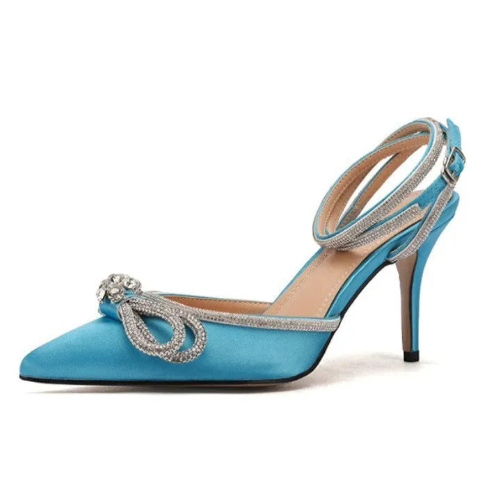Women's black stiletto heel sandals with silk bandage ankle strap and buckle fastening on a pointed toe.