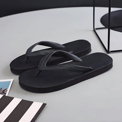 Rubber flip-flops with fish label design on strap, shown in green, red, blue, and black colour options.