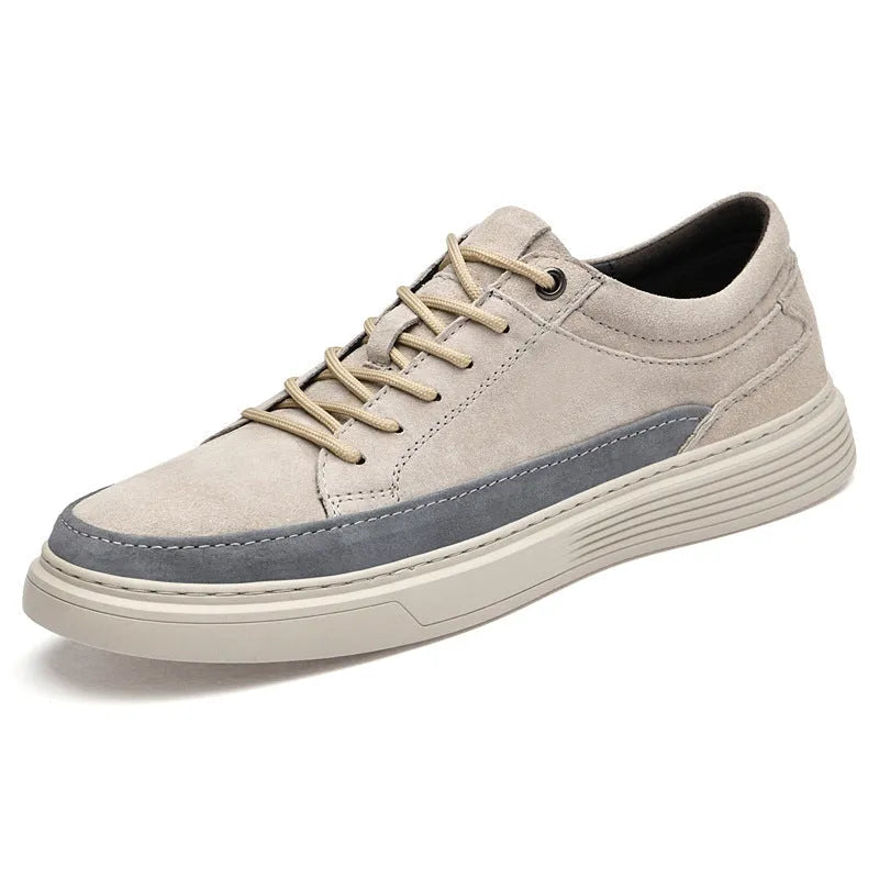 Men's grey low-top casual leather skate shoes with round toe and flat rubber sole on a plain background.