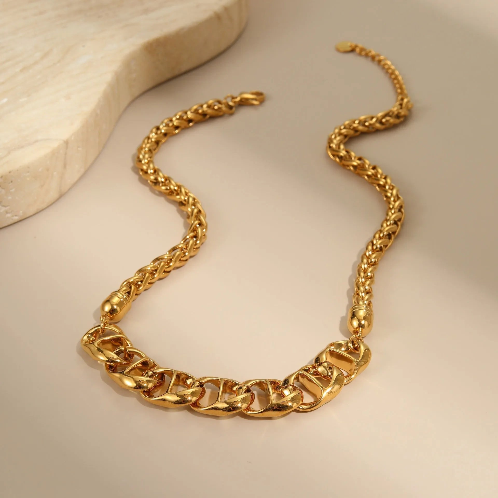 Gold plated stainless steel necklace with geometric pendant for women, shown in two colour options.