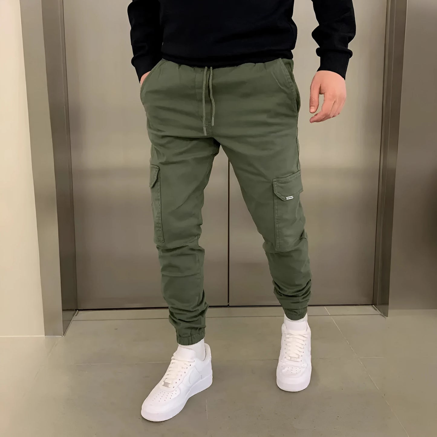 Men's loose-fit straight-leg polyester trousers in Army Green with elastic waistband and patch pockets