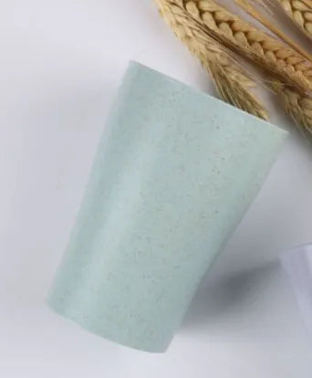 A cylindrical wheat straw plastic bathroom cup in a Nordic colour, holding toothbrushes.