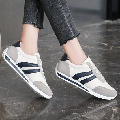 Blue and red low-top lace-up sneaker with soft rubber soles and mesh lining