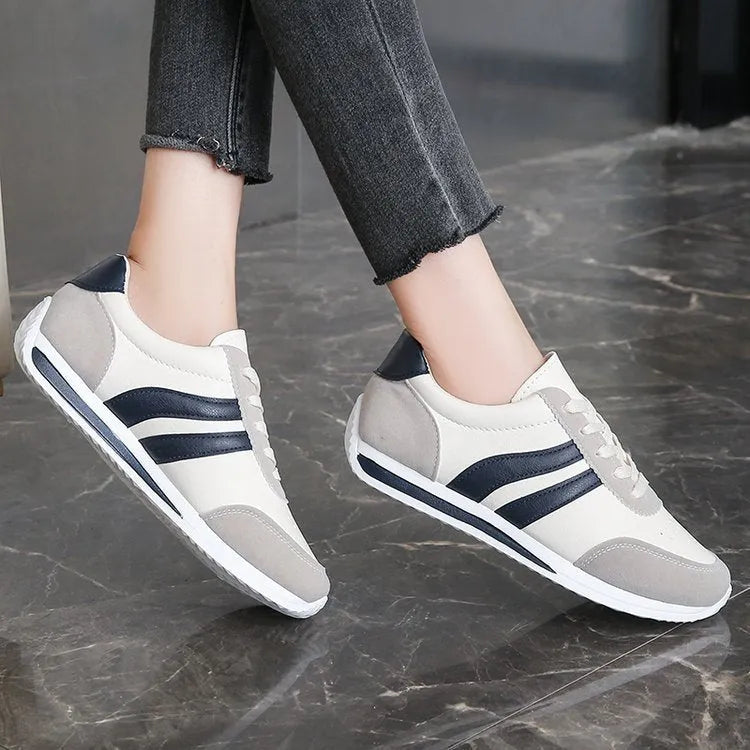 Running leisure sneaker with soft rubber soles and lace-up closure, available in blue and red colours with low-top mesh lining for universal sports wear, sizes UK 35 to 43 with flat heel and injection-moulded sole construction
