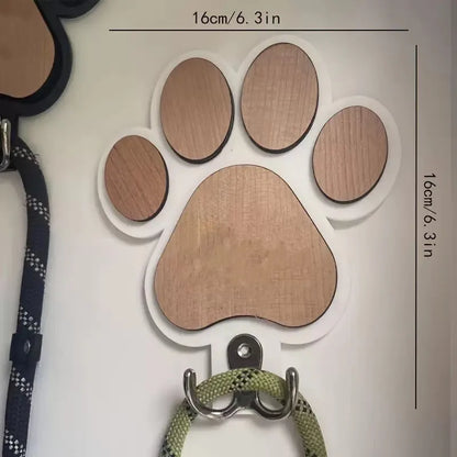 Black wooden wall hook shaped like a paw print foot on a white wall